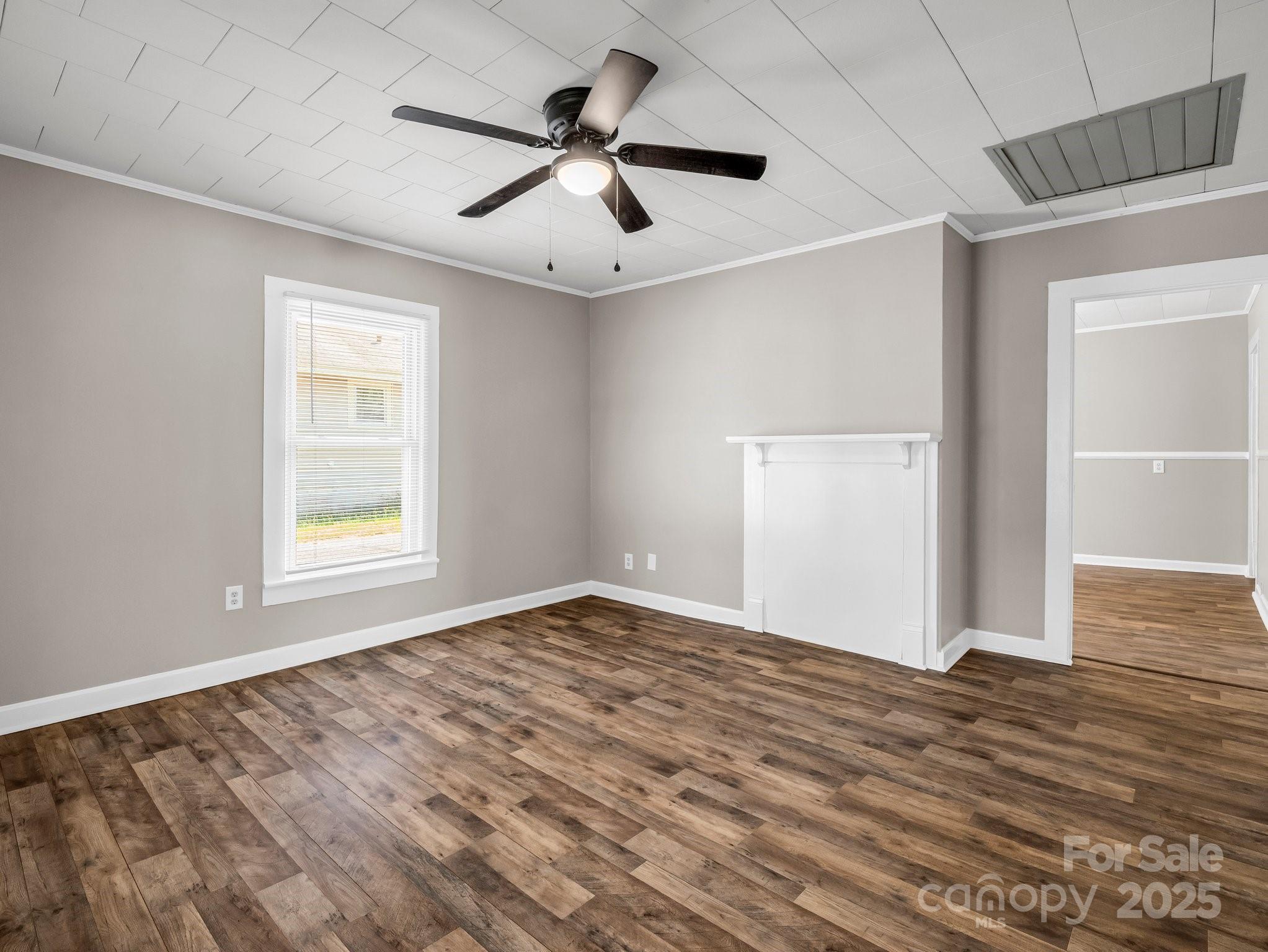 149 Wisconsin Street Spindale, NC 28160 - Photo 6 of 23 an empty room with wooden floor and windows