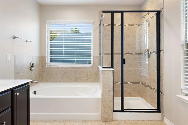 a bathroom with a bathtub and a shower
