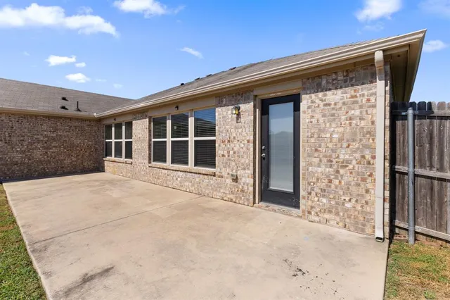 a kitchen with stainless steel appliances granite countertop a stove and a kitchen island with wooden floor