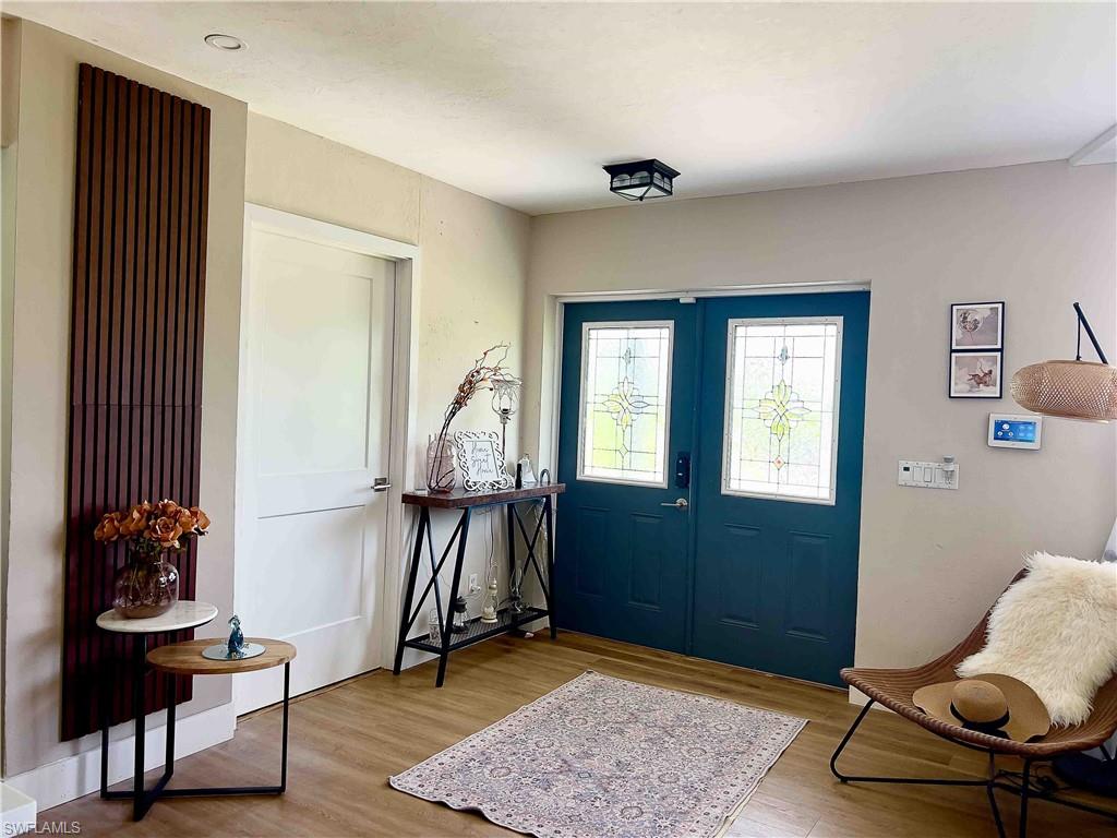 3220 63rd Street Southwest Naples, FL 34105 - Photo 12 of 36 Foyer entrance featuring wood finished floors