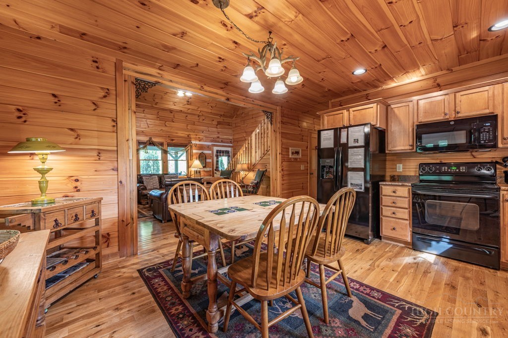 197 Woodby Ridge Road Vilas, NC 28692 - Photo 11 of 45 a dinning table and chairs in a open kitchen