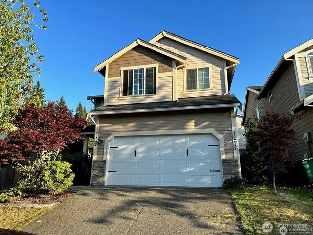 a front view of a house with a garden