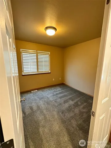 a view of an empty room and a window