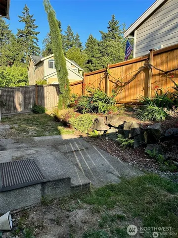 a view of backyard with plants and outdoor seating