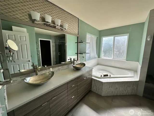 a bathroom with a sink a mirror and a bathtub