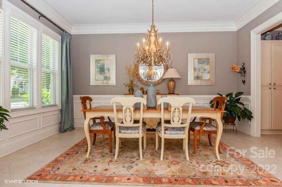 9517 Wheatfield Road Charlotte, NC 28277 - Photo 15 of 41 a dining room with furniture a chandelier and wooden floor