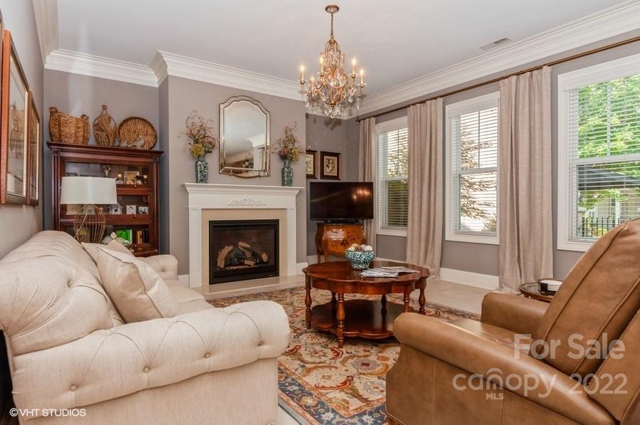 9517 Wheatfield Road Charlotte, NC 28277 - Photo 17 of 41 a living room with furniture chandelier and a fireplace