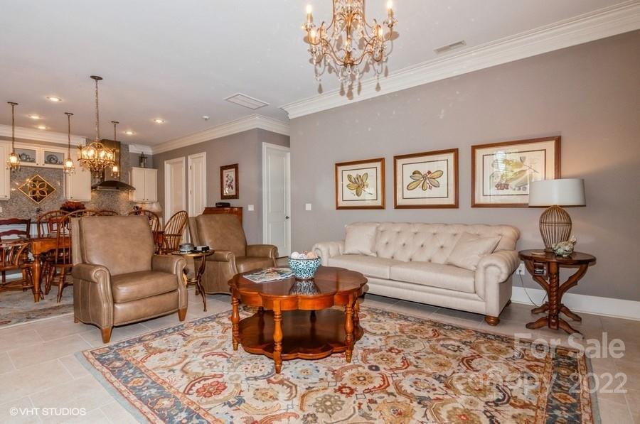 9517 Wheatfield Road Charlotte, NC 28277 - Photo 18 of 41 a living room with furniture and a chandelier
