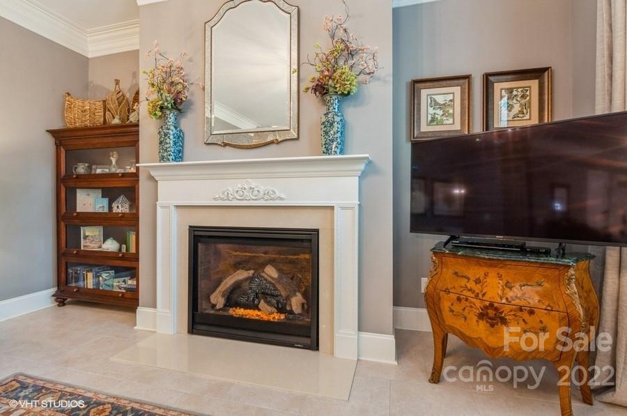 9517 Wheatfield Road Charlotte, NC 28277 - Photo 19 of 41 a living room with furniture a fireplace and a flat screen tv