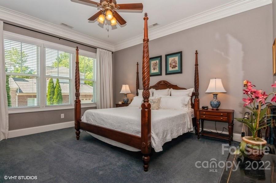 9517 Wheatfield Road Charlotte, NC 28277 - Photo 22 of 41 a bed sitting in a bedroom next to a window