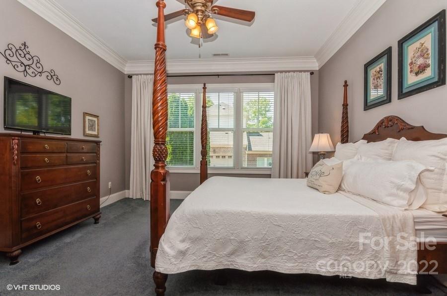 9517 Wheatfield Road Charlotte, NC 28277 - Photo 24 of 41 a bedroom with a bed and a flat screen tv