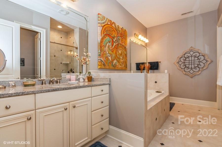 9517 Wheatfield Road Charlotte, NC 28277 - Photo 25 of 41 a bathroom with a sink and a mirror