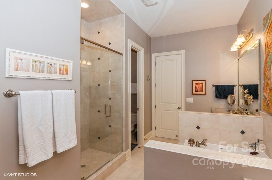 9517 Wheatfield Road Charlotte, NC 28277 - Photo 28 of 41 a bathroom with a tub sink and mirror