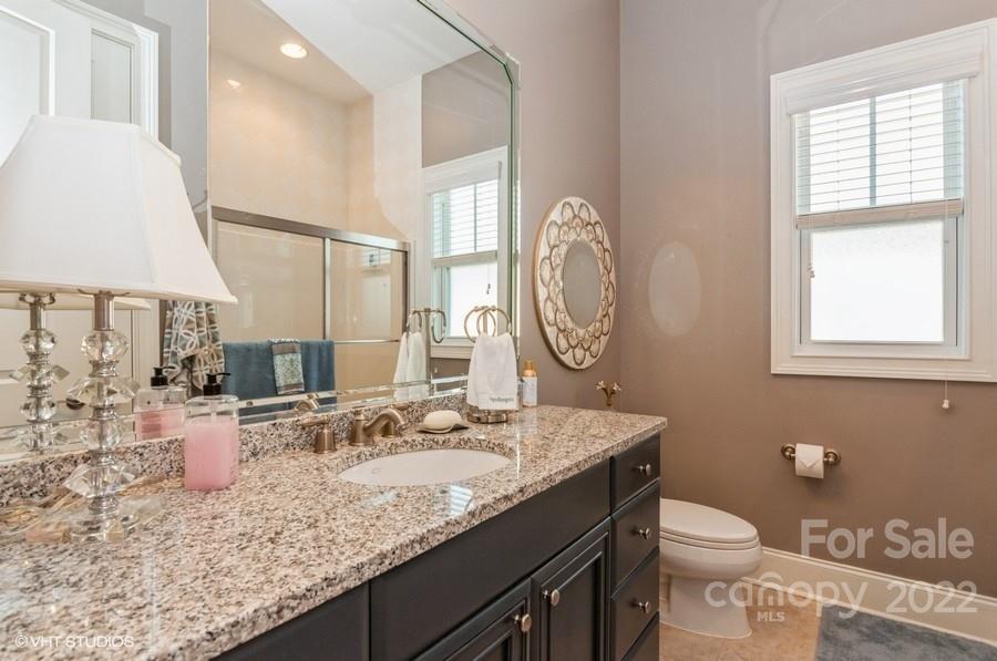 9517 Wheatfield Road Charlotte, NC 28277 - Photo 33 of 41 a bathroom with a granite countertop sink a toilet and a mirror