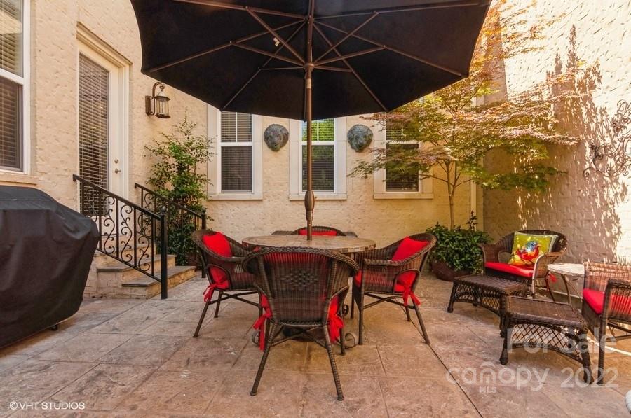 9517 Wheatfield Road Charlotte, NC 28277 - Photo 37 of 41 a roof deck with table and chairs under an umbrella