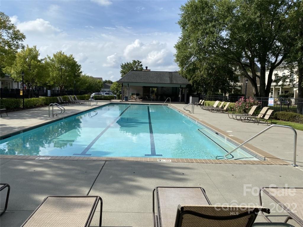 9517 Wheatfield Road Charlotte, NC 28277 - Photo 40 of 41 a small pool with a table and chairs under an umbrella