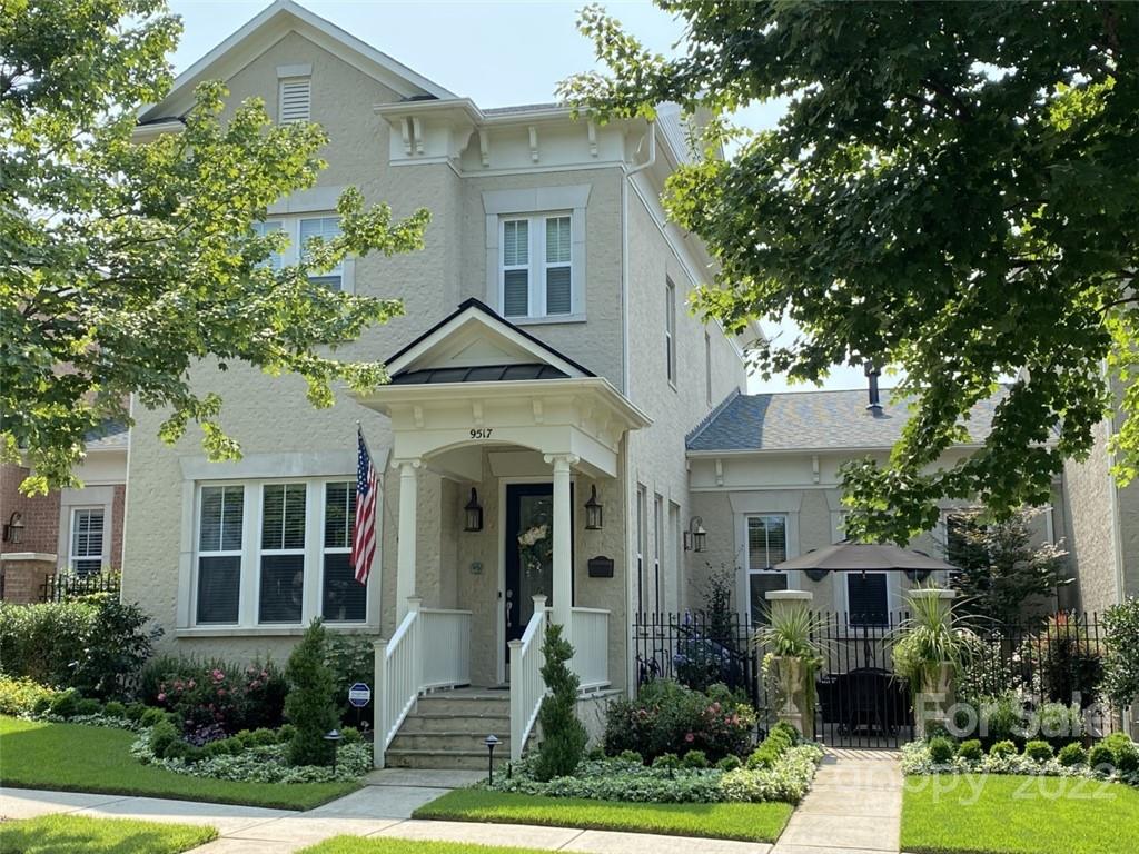 9517 Wheatfield Road Charlotte, NC 28277 - Photo 5 of 41 a front view of a house with a yard and potted plants