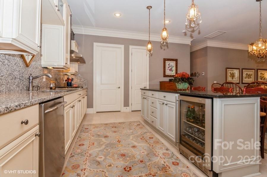 9517 Wheatfield Road Charlotte, NC 28277 - Photo 10 of 41 a kitchen with granite countertop a sink stove and cabinets