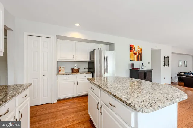 a kitchen with granite countertop a sink stove and refrigerator