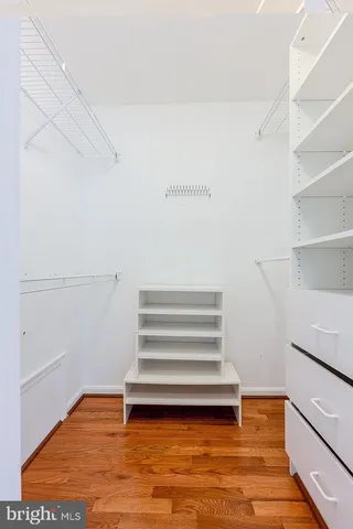a view of room with stairs and wooden floor