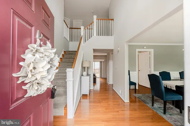 a view of a hallway with furniture and wooden floor