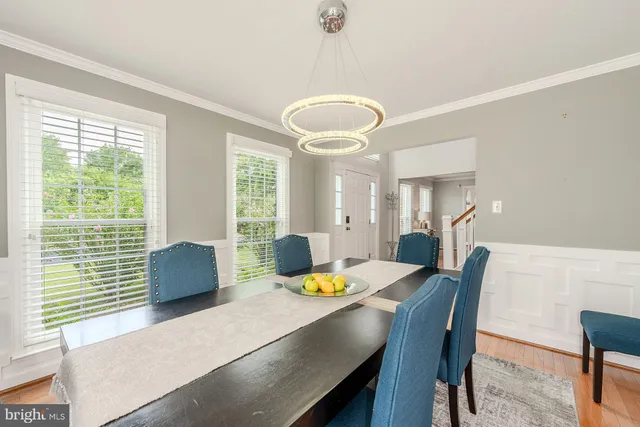 a view of a dining room with furniture and a large window
