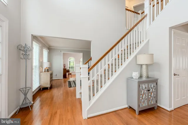 a view of staircase with wooden floor and a rug
