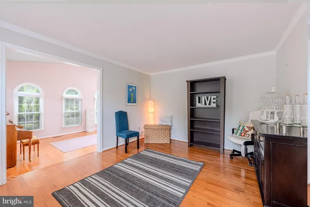a living room with furniture a rug and a piano