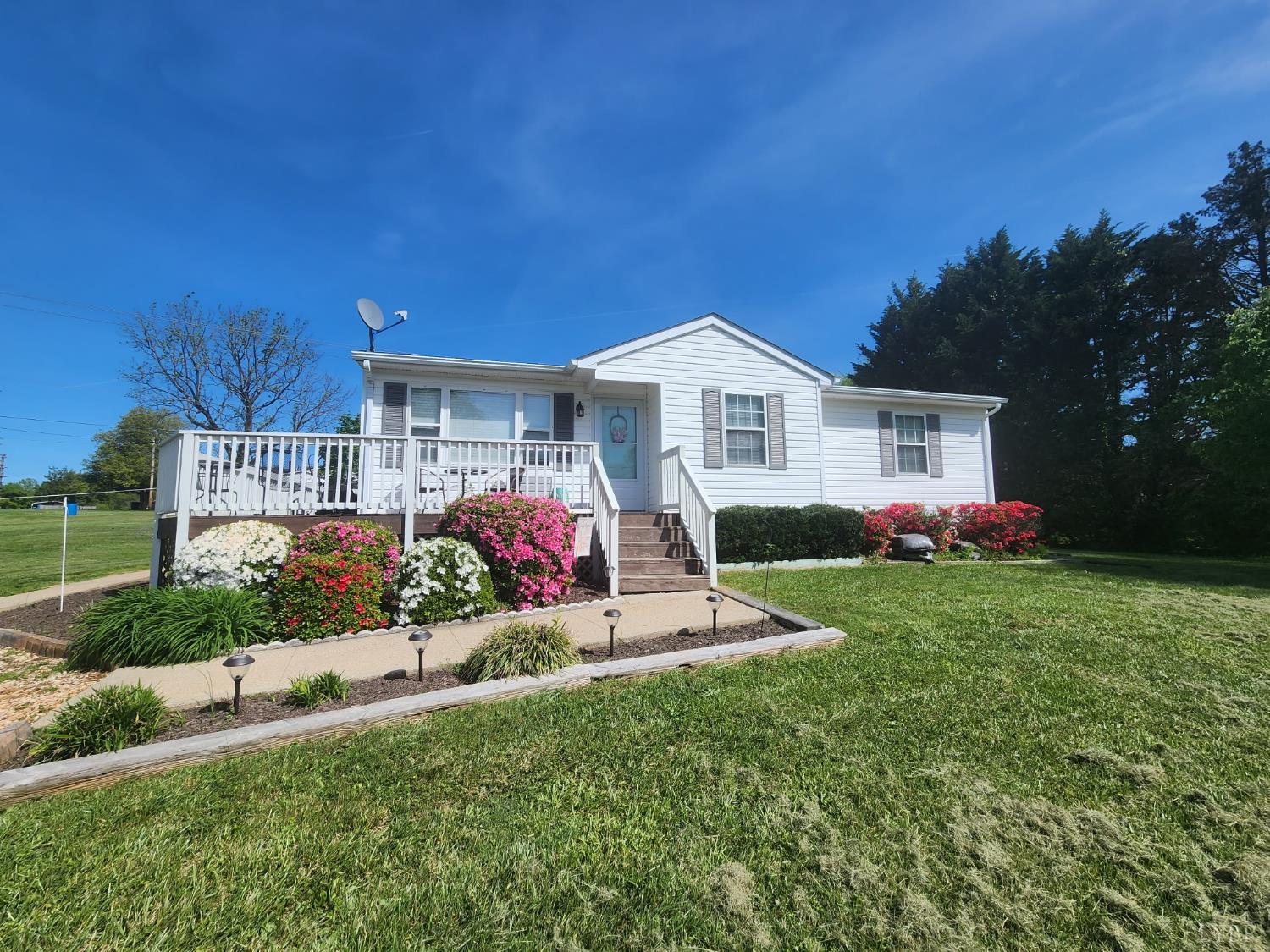 a view of a house with a yard and sitting area