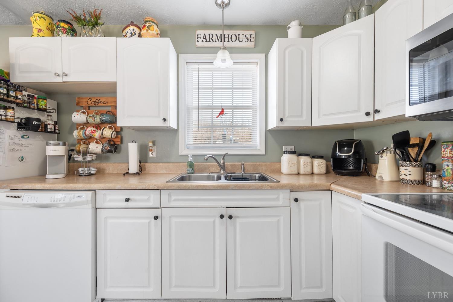 360 Webster Drive Concord, VA 24538 - Photo 13 of 36 a kitchen with white cabinets and sink