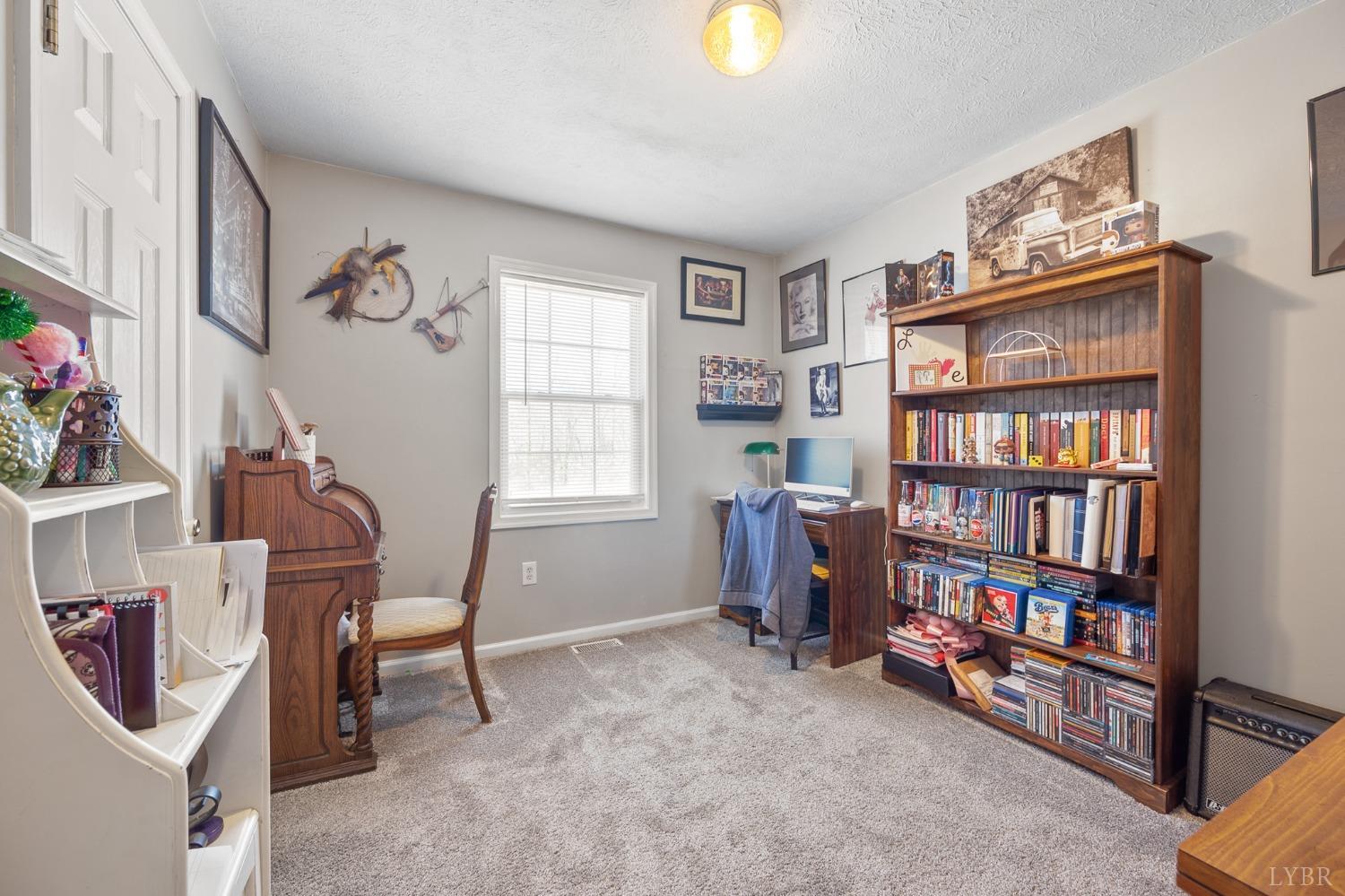 360 Webster Drive Concord, VA 24538 - Photo 16 of 36 a view of a workspace with bookshelf and a window
