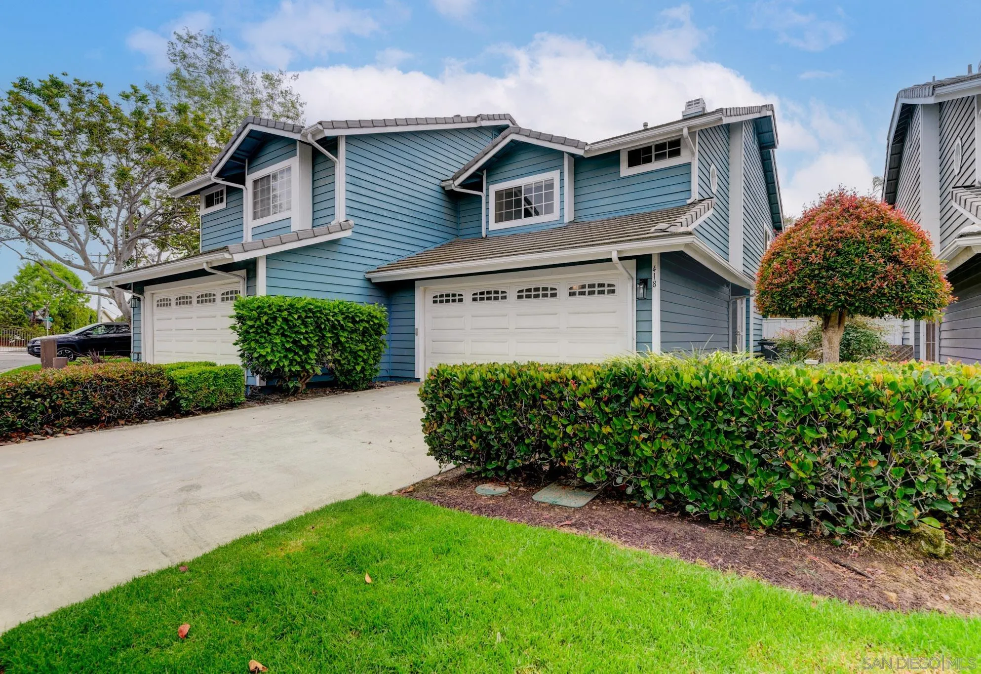 a front view of a house with a garden