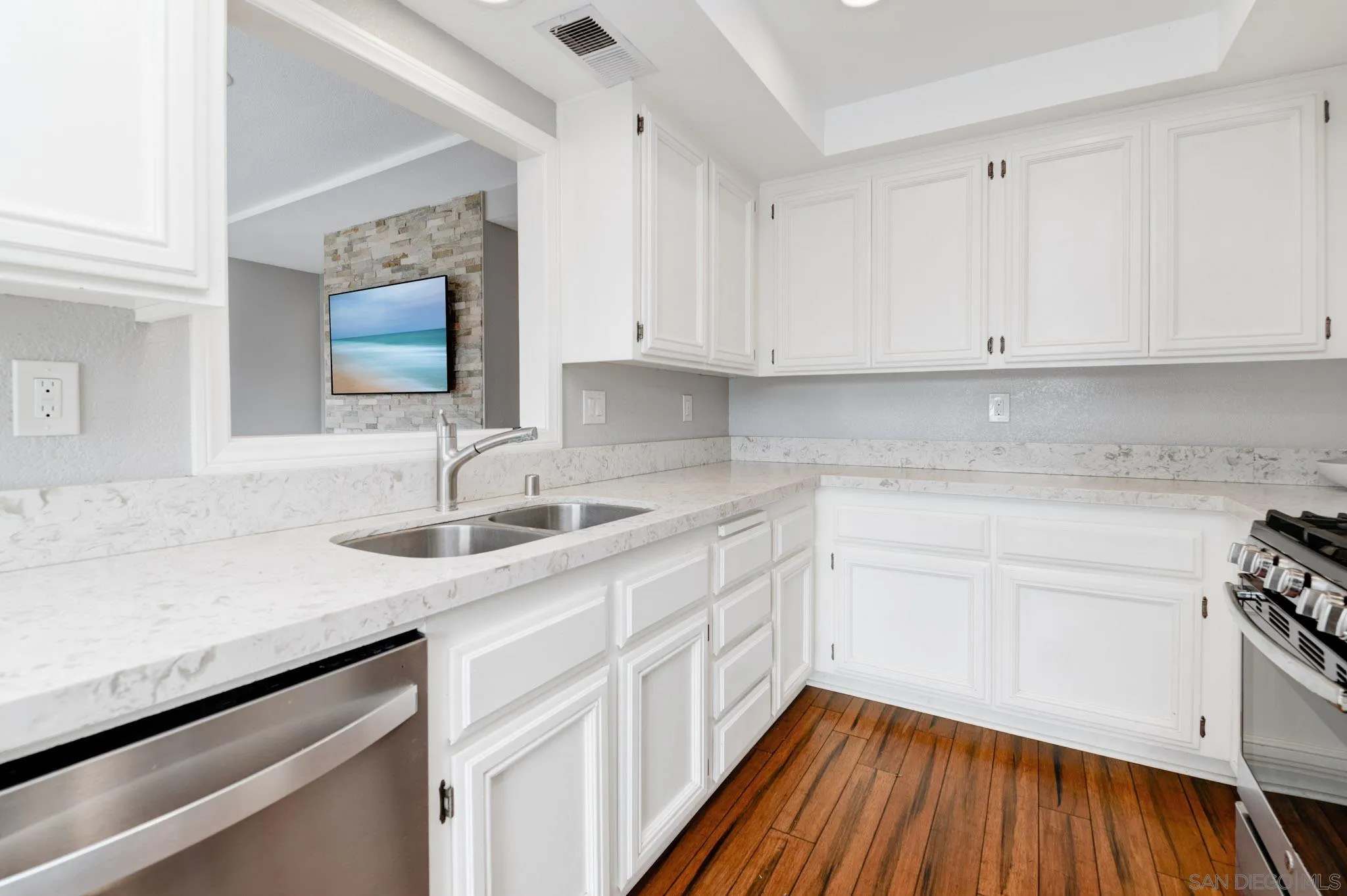 418 Summer View Circle Encinitas, CA 92024 - Photo 11 of 30 a kitchen with a sink dishwasher and white cabinets with wooden floor