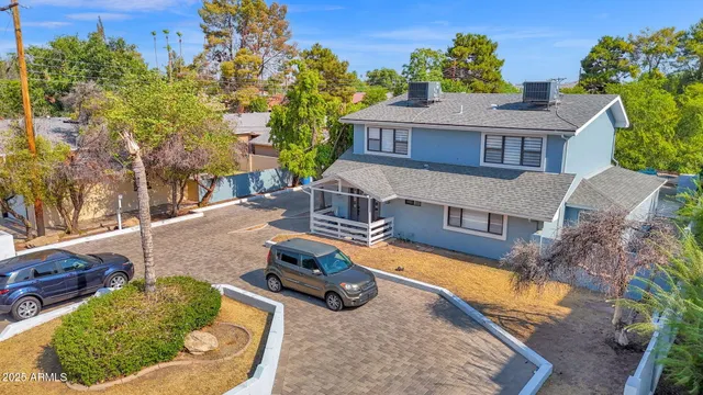 an aerial view of a house with garden space and street view