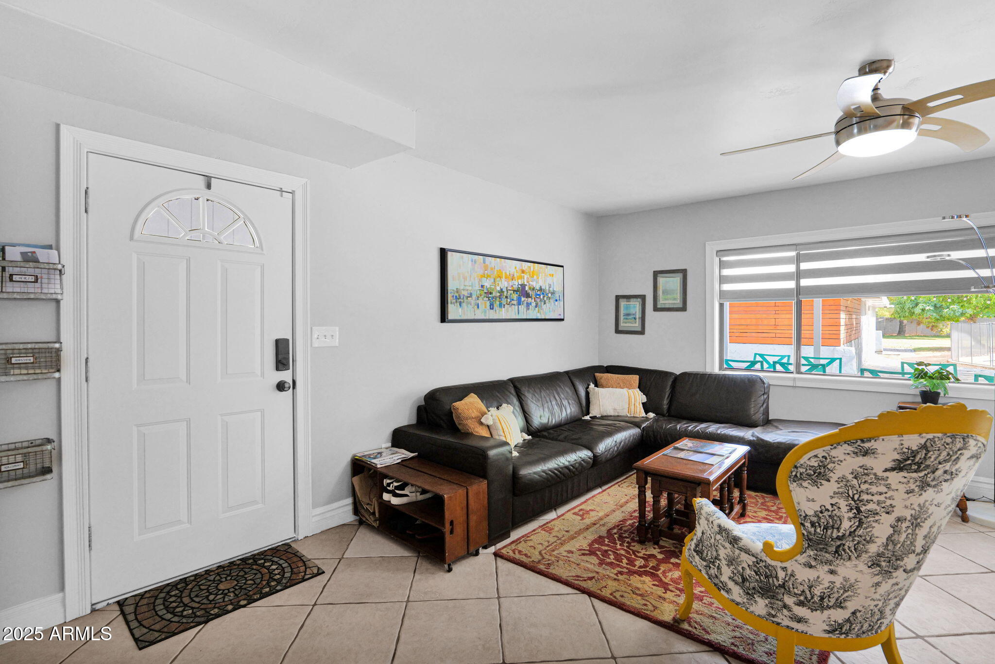 3217 East Flower Street Phoenix, AZ 85018 - Photo 11 of 60 a living room with furniture and a large window