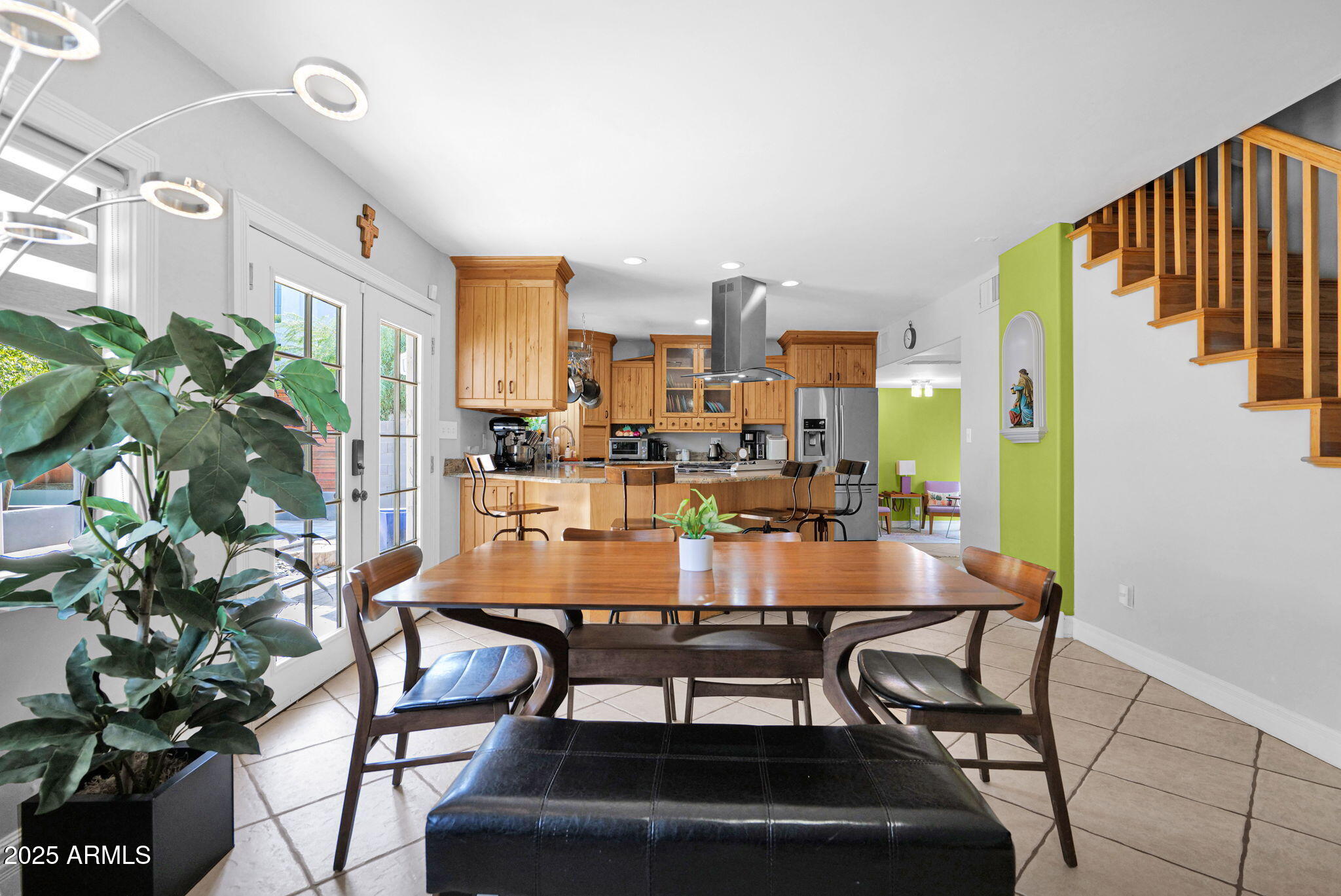 3217 East Flower Street Phoenix, AZ 85018 - Photo 15 of 60 a view of a dining room with furniture and a potted plant