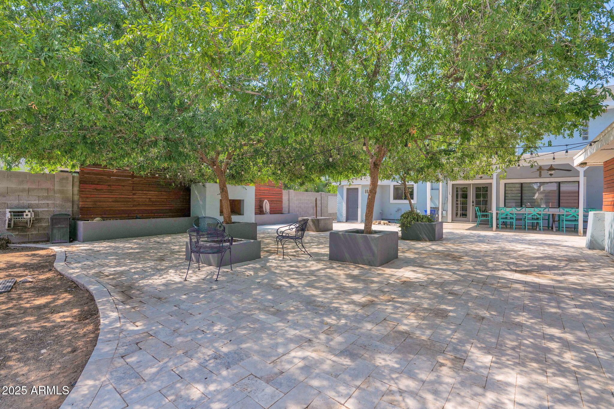 3217 East Flower Street Phoenix, AZ 85018 - Photo 29 of 60 a view of a chairs and tables in the backyard of the house