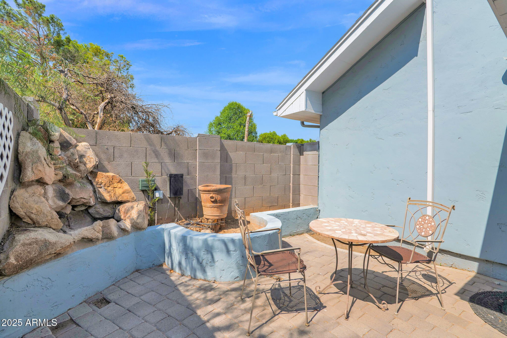 3217 East Flower Street Phoenix, AZ 85018 - Photo 35 of 60 a view of a patio with table and chairs and potted plants