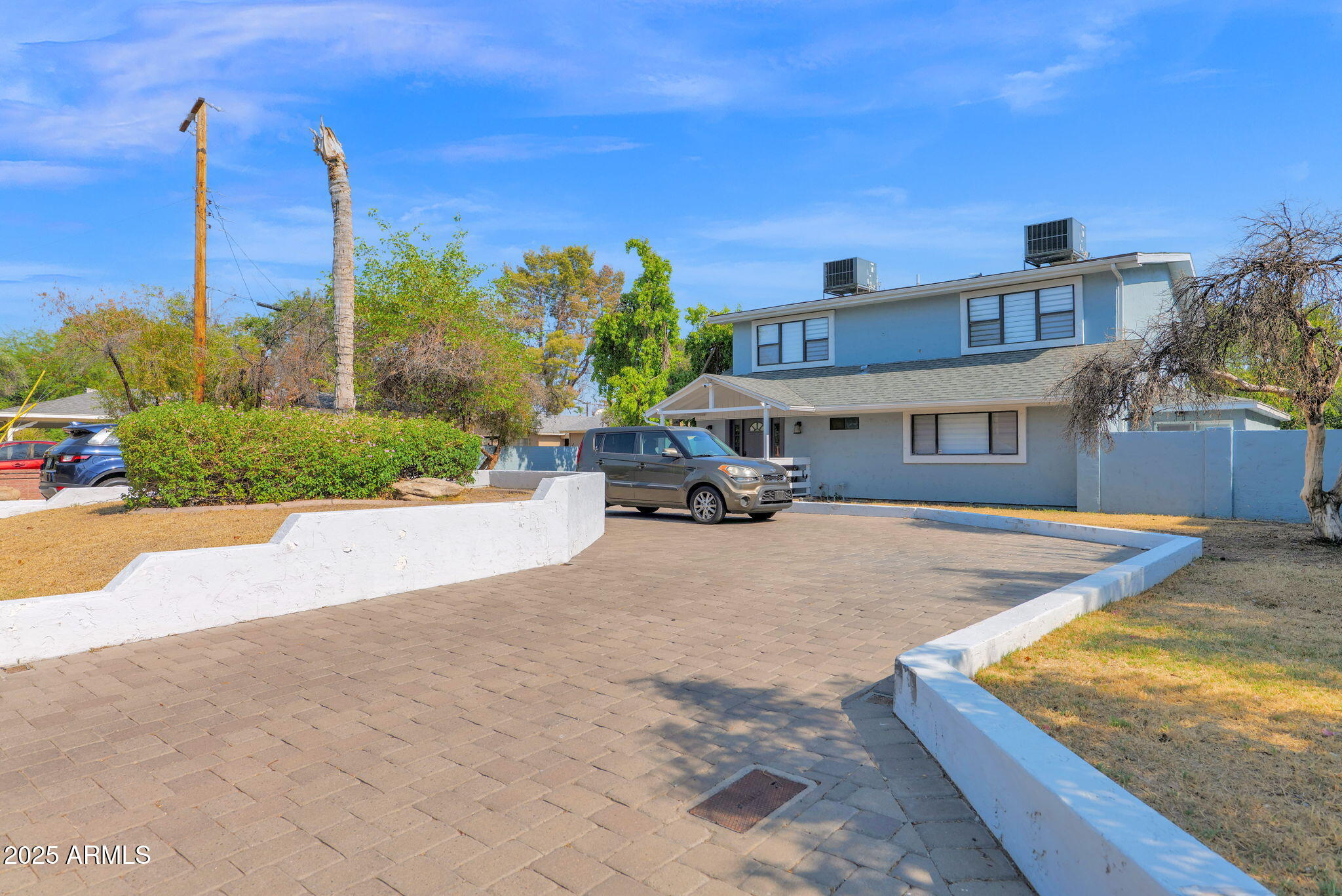 3217 East Flower Street Phoenix, AZ 85018 - Photo 4 of 60 a front view of a house with a yard and car parked