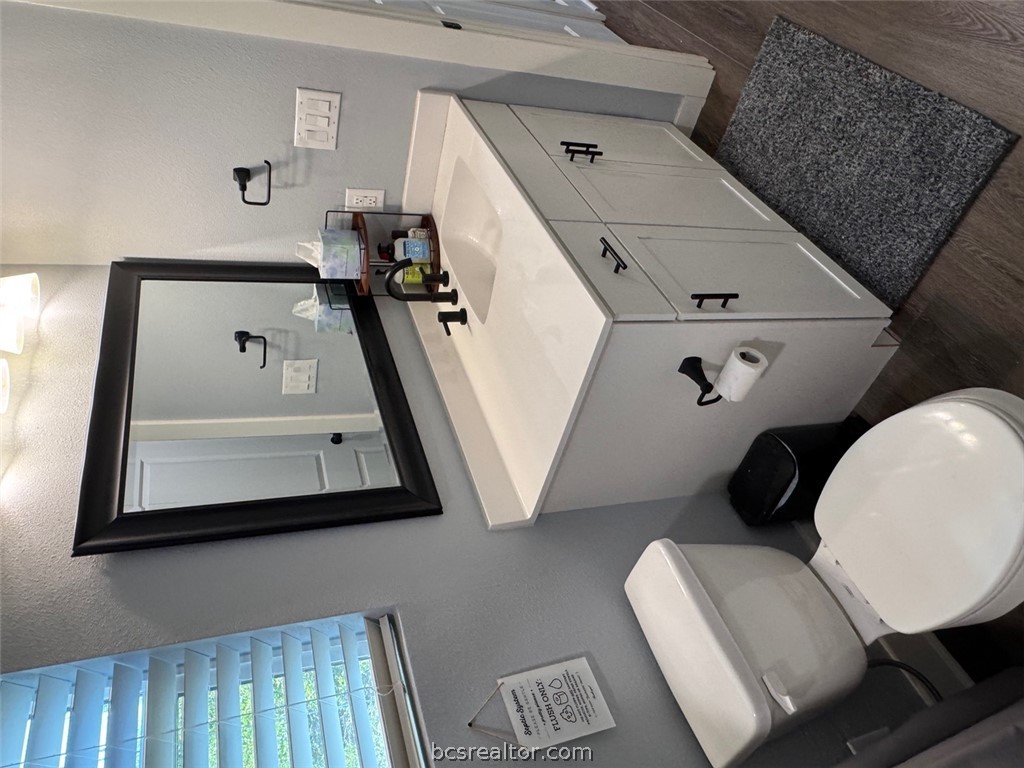3454 Co Road Marquez, TX 77865 - Photo 24 of 35 a bathroom with a toilet a sink and mirror