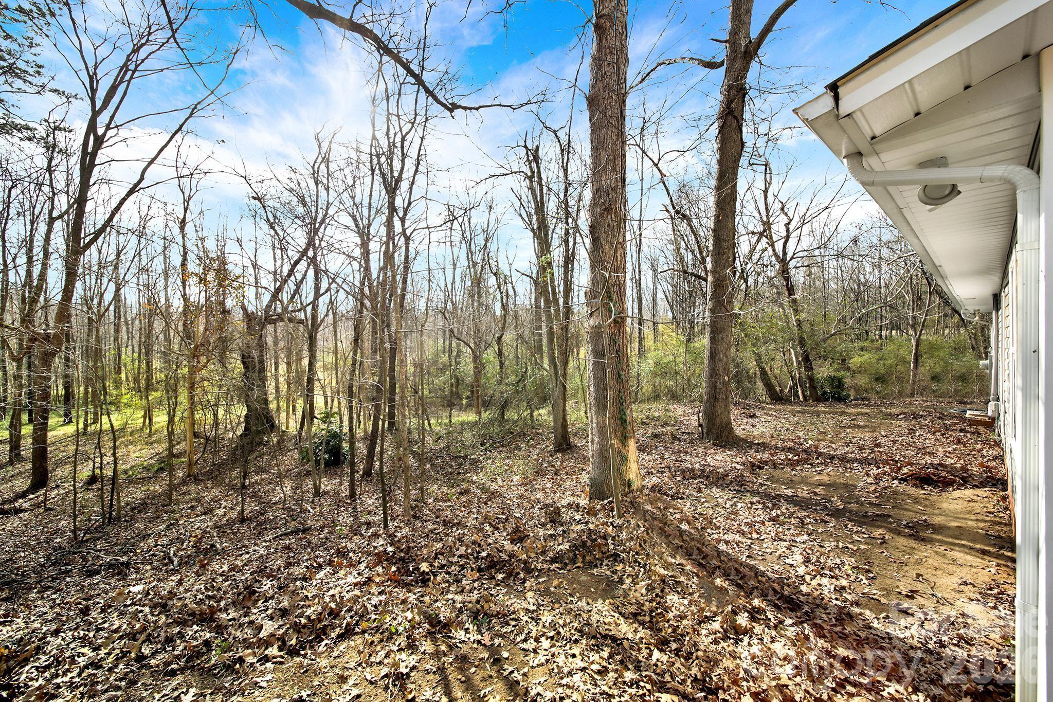 2503 Lancaster Highway Monroe, NC 28112 - Photo 22 of 26 a backyard of a house with lots of green space