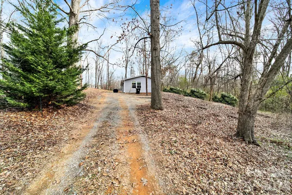 a backyard of a house with large trees