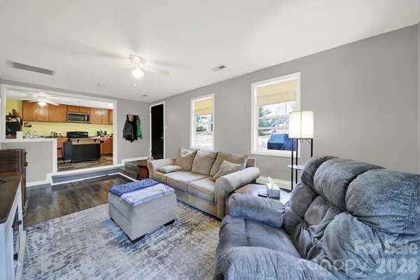 a living room with furniture or couch and a wooden floor