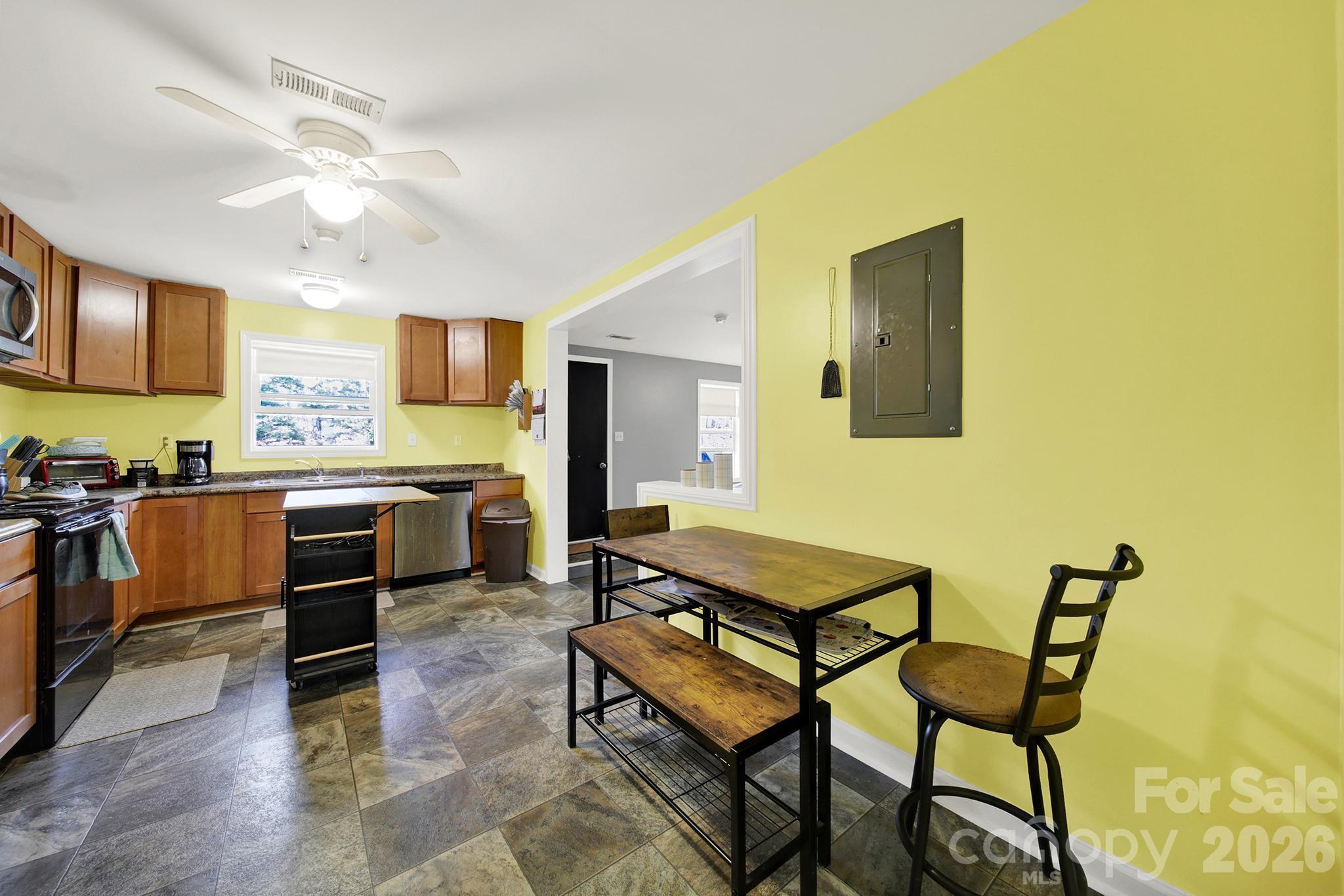 2503 Lancaster Highway Monroe, NC 28112 - Photo 7 of 26 a kitchen with stainless steel appliances kitchen island granite countertop a stove a sink and a microwave