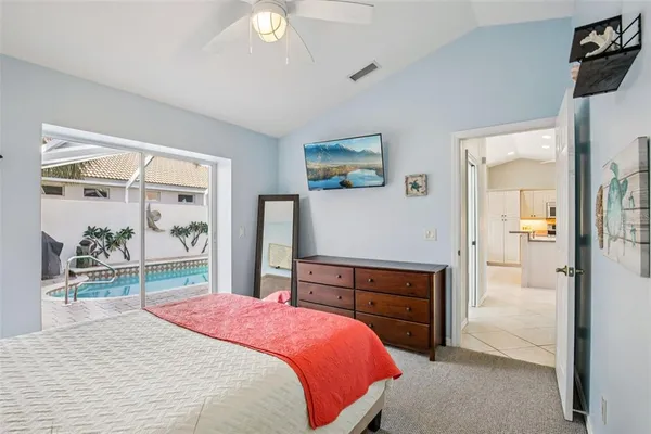 a bedroom with a bed and a large mirror