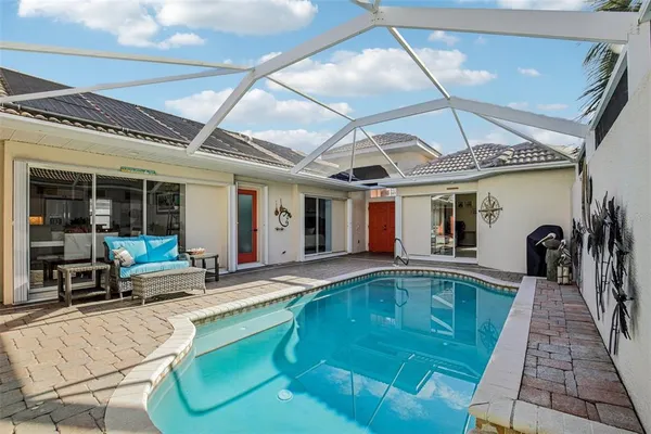 a swimming pool with outdoor seating