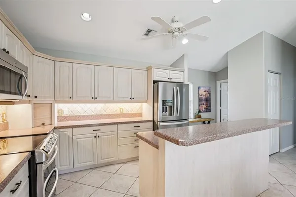 a kitchen with a sink a stove and cabinets