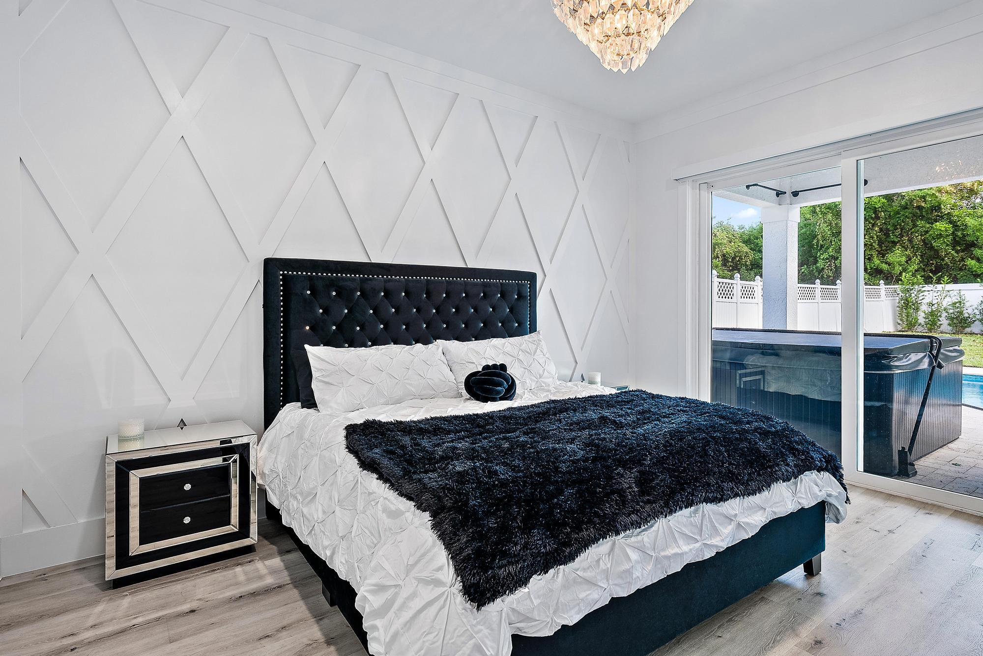 596 North Cypress Drive Tequesta, FL 33469 - Photo 17 of 28 a bedroom with a bed and a window