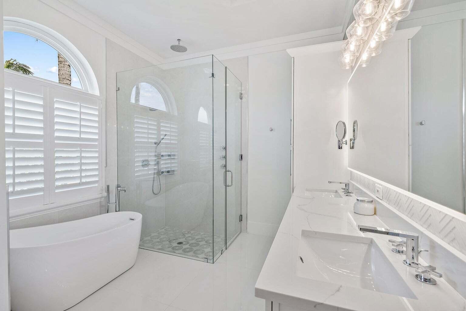596 North Cypress Drive Tequesta, FL 33469 - Photo 19 of 28 a bathroom with a bathtub and a shower