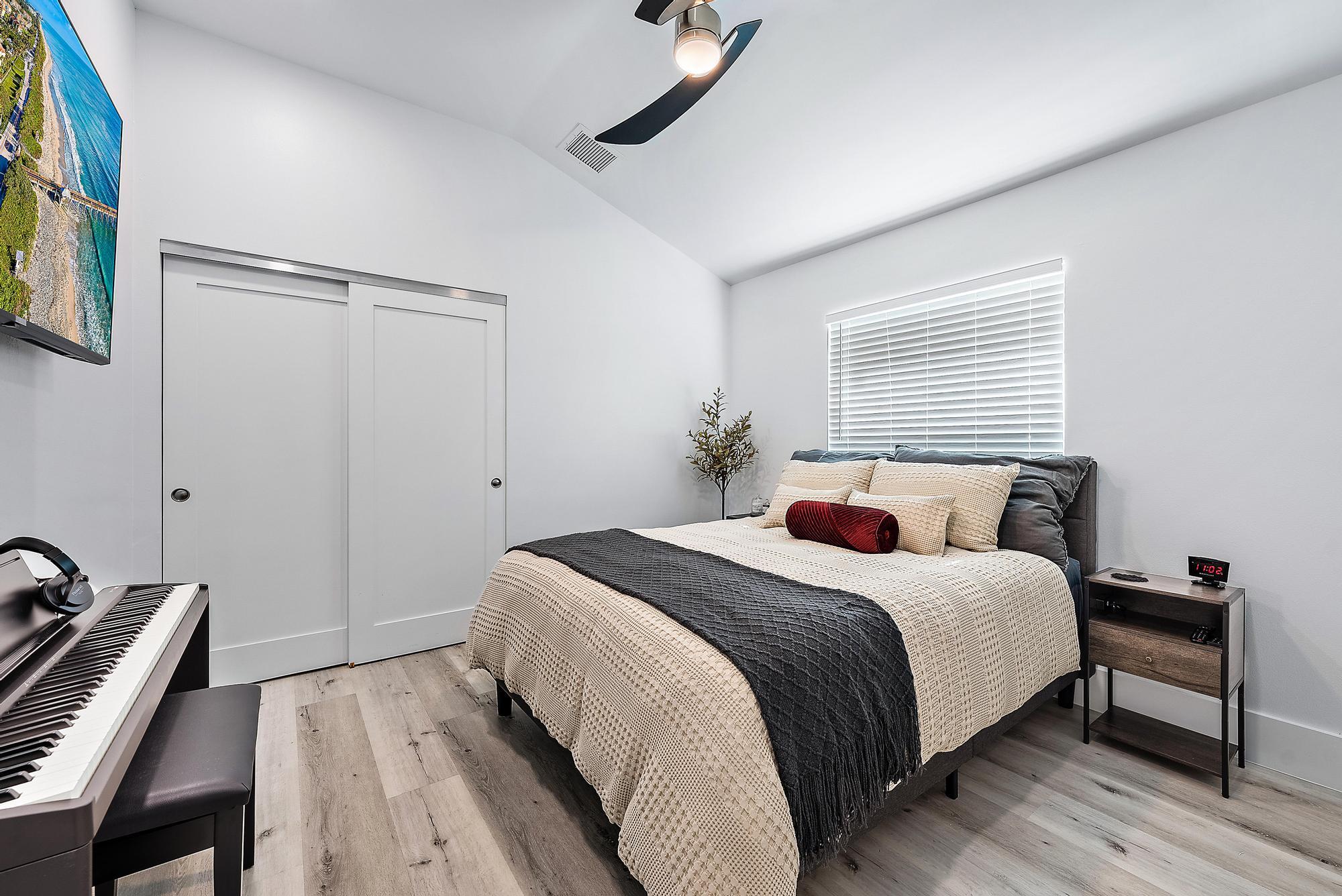 596 North Cypress Drive Tequesta, FL 33469 - Photo 21 of 28 a bedroom with a bed and a dresser